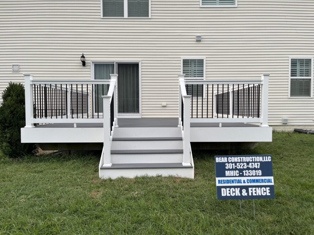 White deck with stairs and a Bear Construction sign