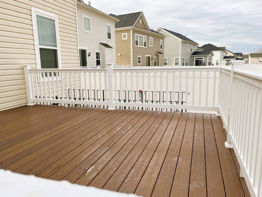 Brown composite deck with white railing